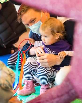 A child uses a sensory toy in an International Dance Day activity