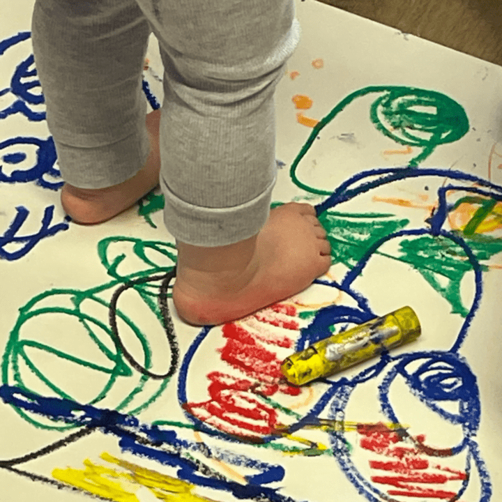 A child stands on a painted picture during an activity run by a Little Learners franchisee