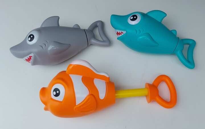 Water squirter toys in the shapes of fish and sharks