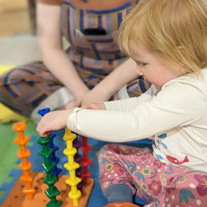 A happy child sorts colours