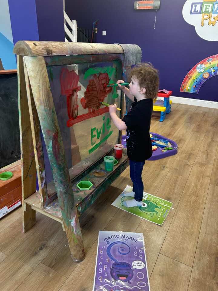 A child mark making with paint at a Home Ed and SEND session at Little Learners Playspace Ashington 