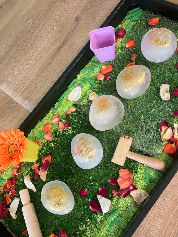 Frozen Easter Eggs in a garden themed tuff tray 