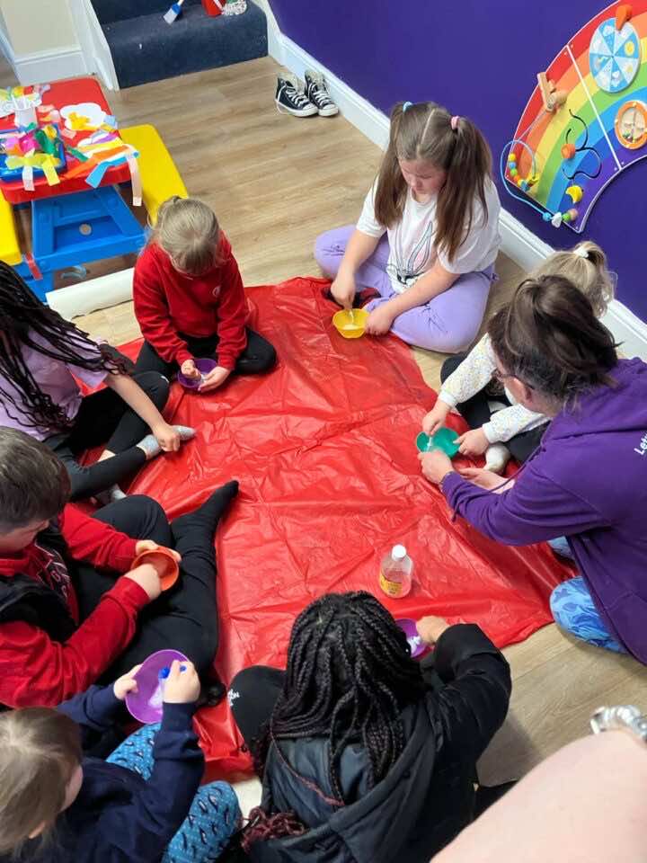 Children sit in a circle at Playspace Ashington and make slime as part of HAF activities 