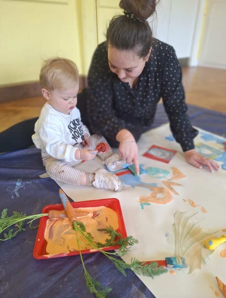 Baby painting with mum