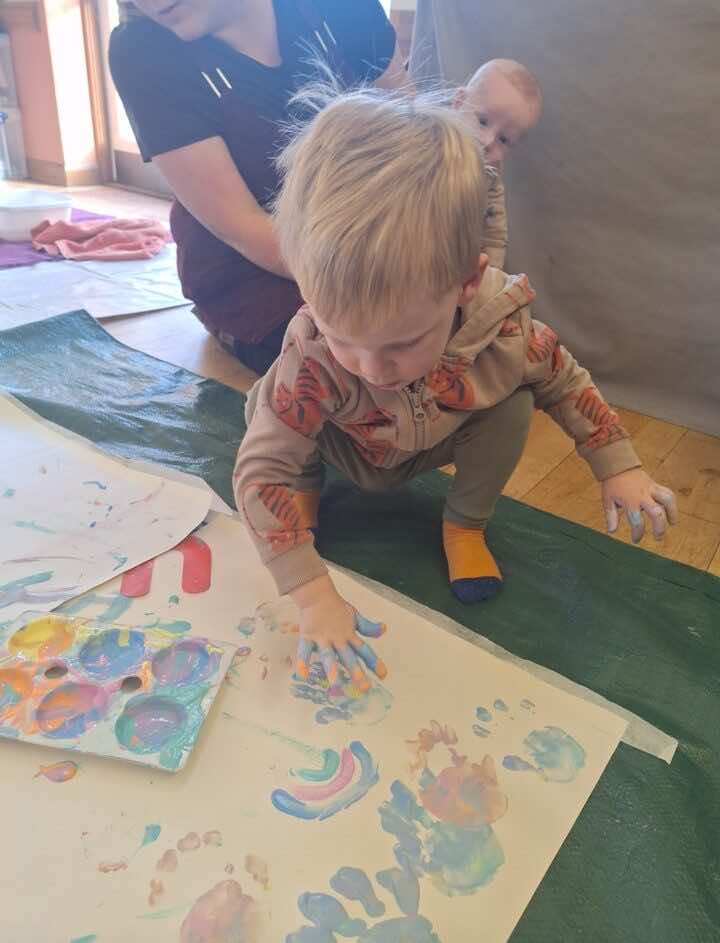 Toddler painting with hands