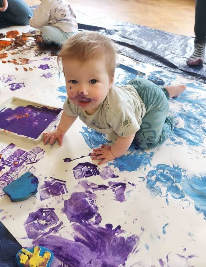 Baby crawling in paint