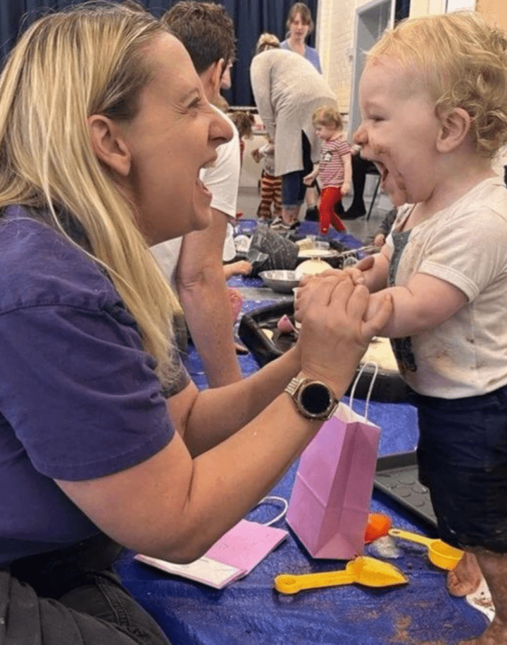 Kim from Little Learners Winchester plays with a child at a messy play class 